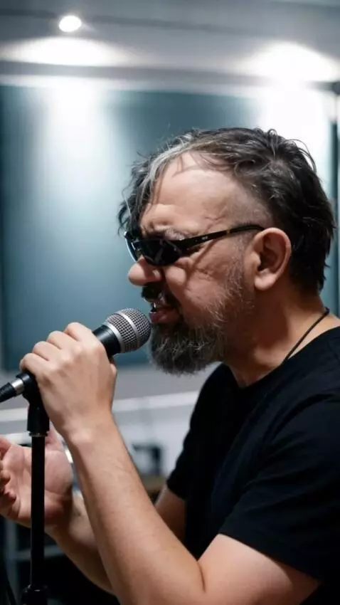 AI Video from prompt: A man wearing dark glasses, his face an exact re