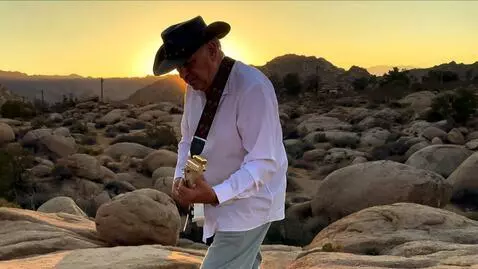 AI Video from prompt: the lead guitarist plays a blistering solo at su