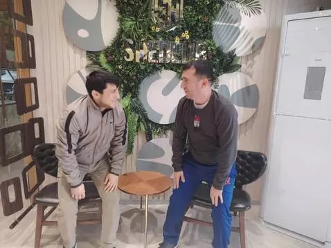 AI Video from prompt: Two young boys sitting at a table stand up and w