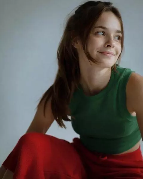 AI Video from prompt: the girl smiled faintly and then stopped. her he