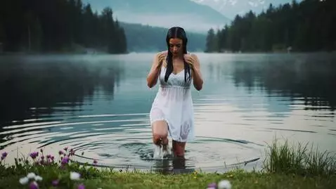 AI Video from prompt: The young woman emerges from the lake.