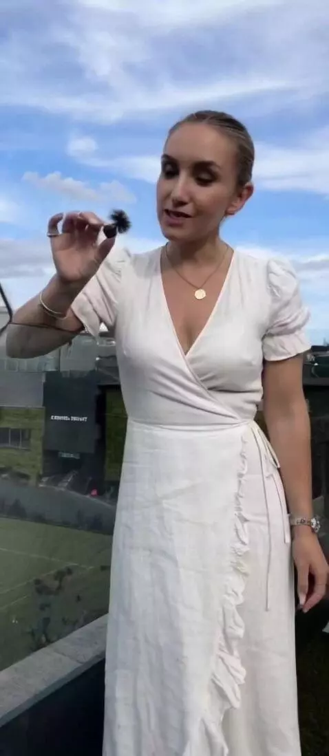 AI Video from prompt: The woman unties her dress and pulls it open wit