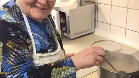AI Video from prompt: It's the woman in the kitchen, wearing a plaid a