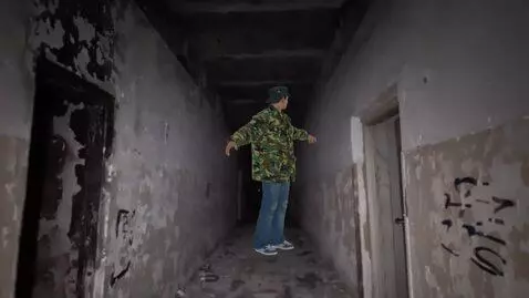 AI Video from prompt: The man in the photo is walking down the hallway