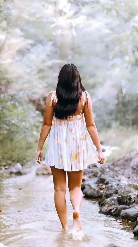 AI Video from prompt: The girl adjusts  her  short