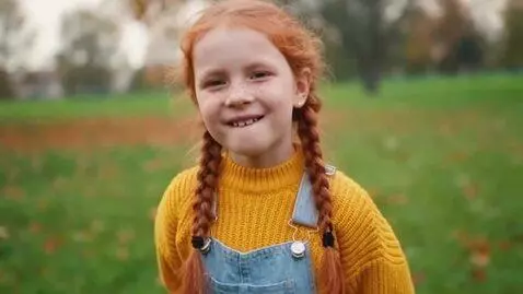 AI Video from prompt: 8 year old girl with ginger hair and freckles pu