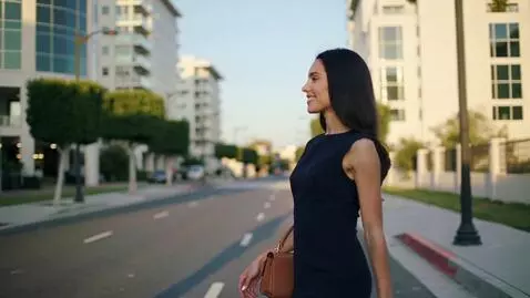 AI Video from prompt: A girl walks gracefully down a city street. An e