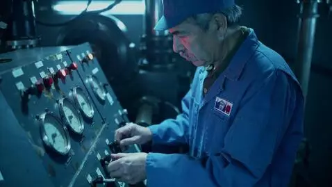 AI Video from prompt: Medium shot of a real engineer in a blue work un