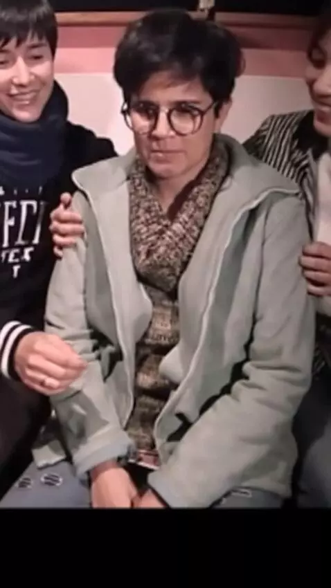 AI Video from prompt: The woman is embraced from behind by a couple