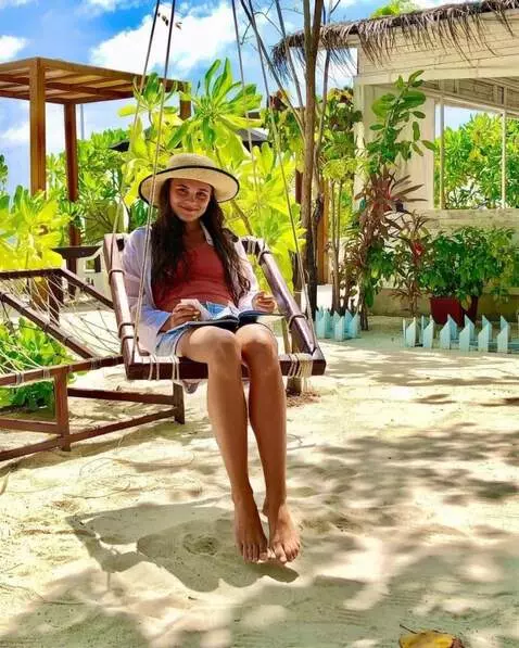 AI Video from prompt: the girl is slowly swinging on the swings. her f