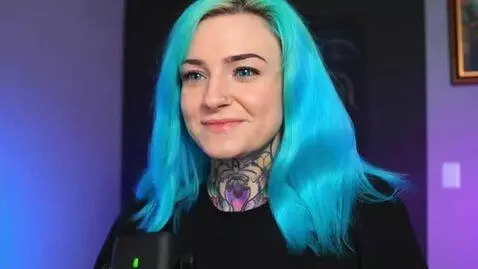 AI Video from prompt: girl adjusts her hair and smiles to camera