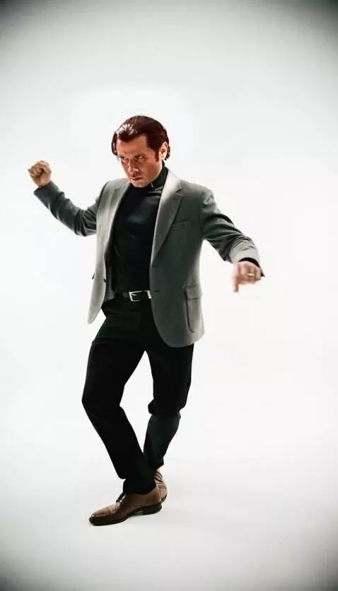 AI Video from prompt: A man dances the twist from the movie starring T