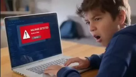 AI Video from prompt: A kid surprised looking at his pc and that pc ha