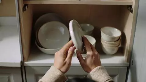 AI Video from prompt: Stack and arrange 3-5 dishes items on a shelf or