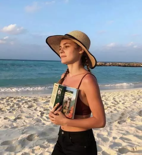 AI Video from prompt: the girl is walking along the beach. her facial 