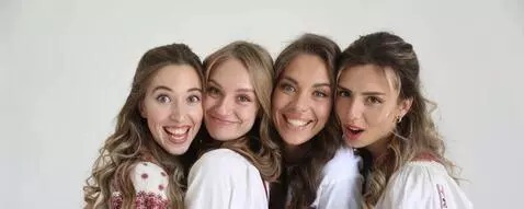 AI Video from prompt: 4 womans smiles shyly as she approaches the came