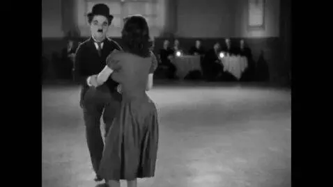 AI Video from prompt: Charlie Chaplin and Paulette Goddard dancing.