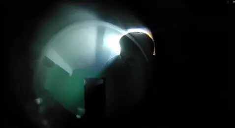AI Video from prompt: Behind the peephole, a terrible spot appears fro