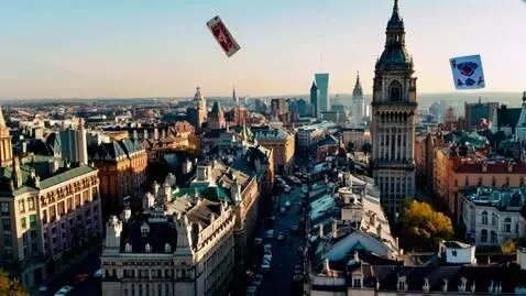 AI Video from prompt: Camera pans London with playing cards flying aro