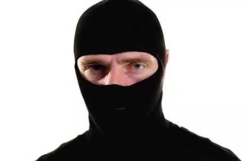 AI Video from prompt: a man in a black balaclava, studio background, l