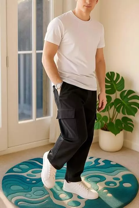 AI Video from prompt: "A man wearing black cargo pants poses stylishly