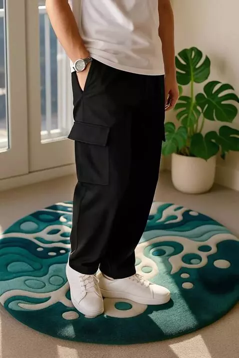 AI Video from prompt: "A man wearing black cargo pants poses stylishly