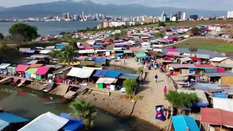 AI Video from prompt: A vibrant, bustling informal settlement scene wi