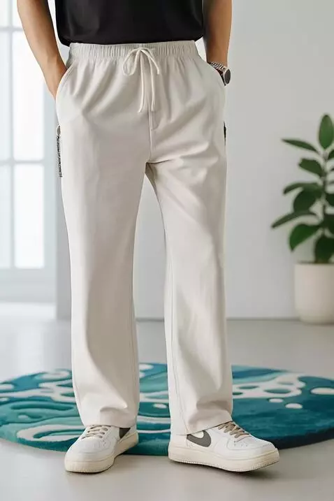 AI Video from prompt: A model in off-white drawstring pants and classi
