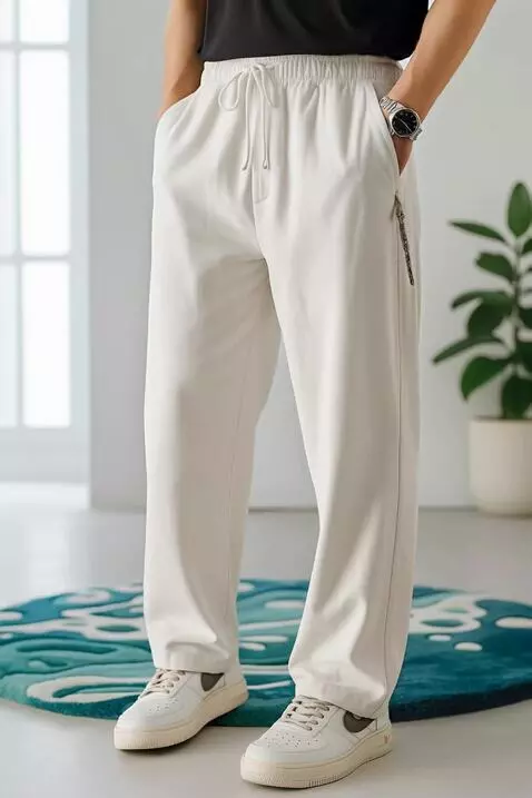 AI Video from prompt: A relaxed male model in cozy cream joggers poses