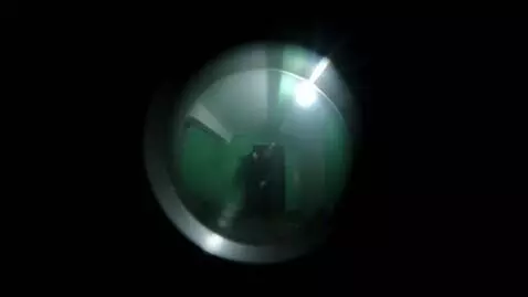 AI Video from prompt: A scary figure smoothly floats out of the dark d