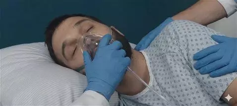 AI Video from prompt: The patient takes long deep breaths into the oxy