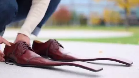 AI Video from prompt: Shoes with very long toes that look like paddles