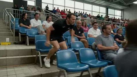 AI Video from prompt: The camera follows a man sitting in the stands a