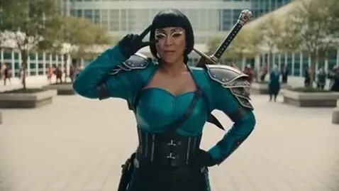 AI Video from prompt: a cosplayer woman, she strikes a pose then becom