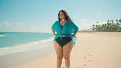 AI Video from prompt: Latina, on a beach, weight gain, she becomes 900