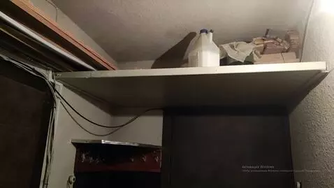 AI Video from prompt: From a shelf near the ceiling, the scary, terrib