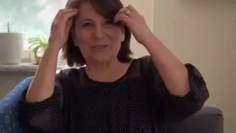 AI Video from prompt: This woman will smile and straighten her hair.