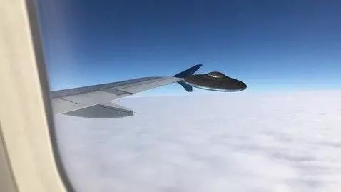 AI Video from prompt: someone is looking out their airplane window whi