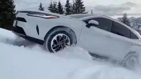 AI Video from prompt: A white 2022 Toyota Venza is speeding down snow-