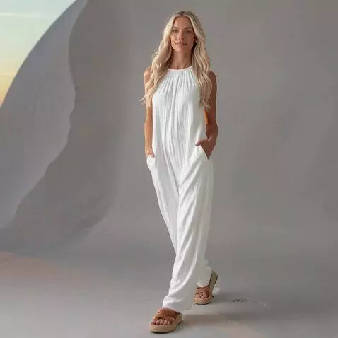 AI Video from prompt: A woman strolls along the beach at sunset, her h