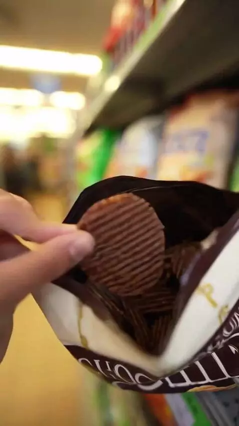 AI Video from prompt: This girl walks into a store looking for chocola