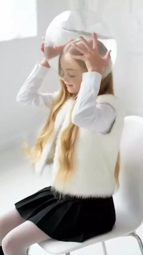 AI Video from prompt: A girl sits on a chair and puts a transparent ro
