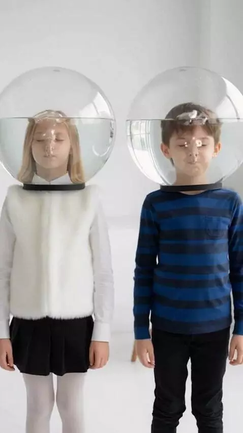 AI Video from prompt: A girl and a boy stand with two transparent roun