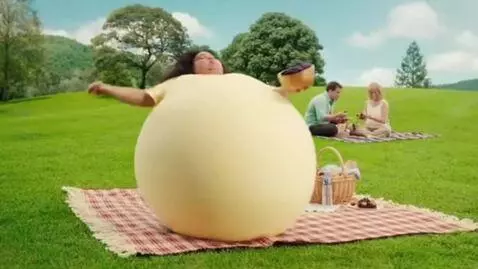 AI Video from prompt: Green park hill, sunny. A woman on a picnic blan