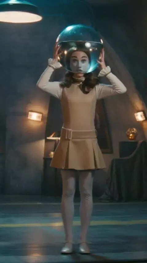 AI Video from prompt: A girl puts a transparent round aquarium with wa