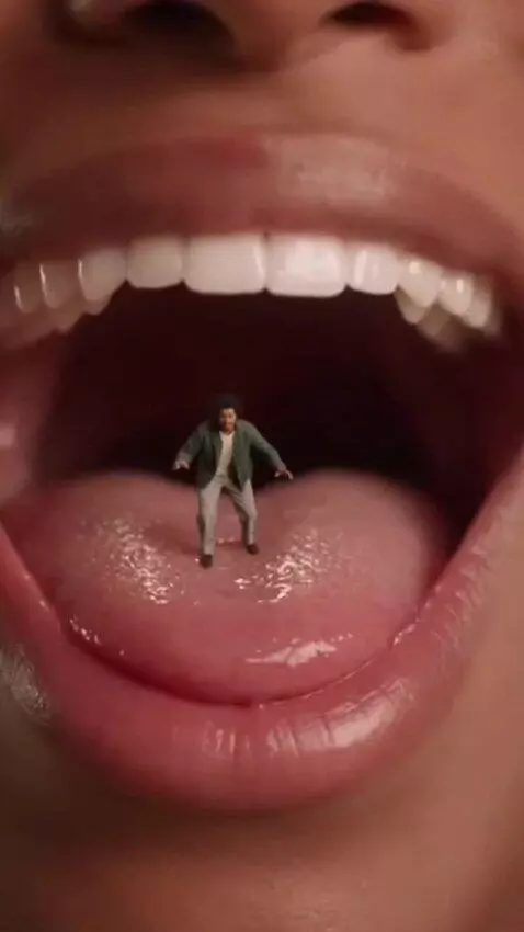 AI Video from prompt: A shrunken person inside a woman’s mouth
