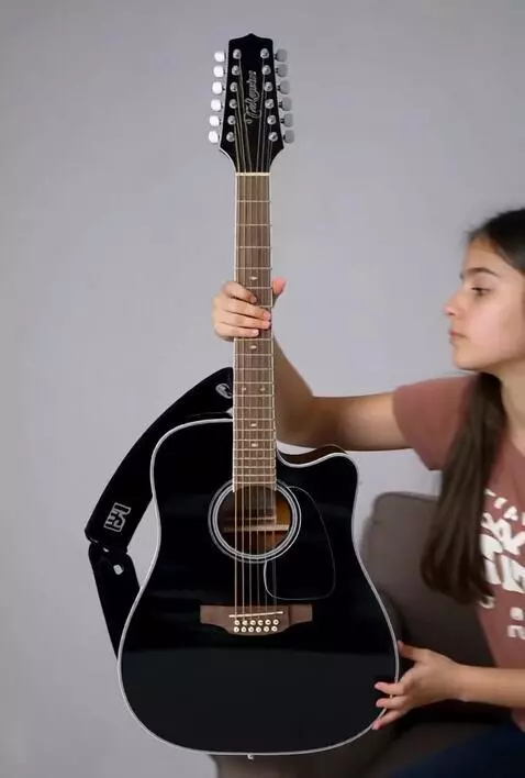 AI Video from prompt: A girl playing strumming this exact 41 inch size