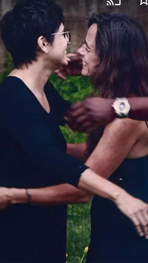AI Video from prompt: An atractive black man hugs both women