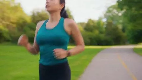AI Video from prompt: a woman jogging, her chest becomes bigger as she