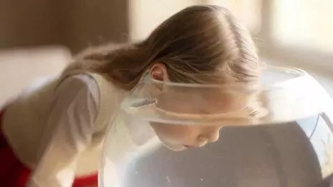 AI Video from prompt: The girl approaches a table with a transparent r